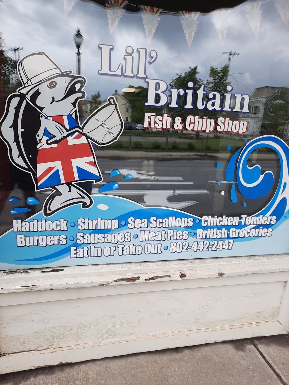 Menu board with fish and chips options.